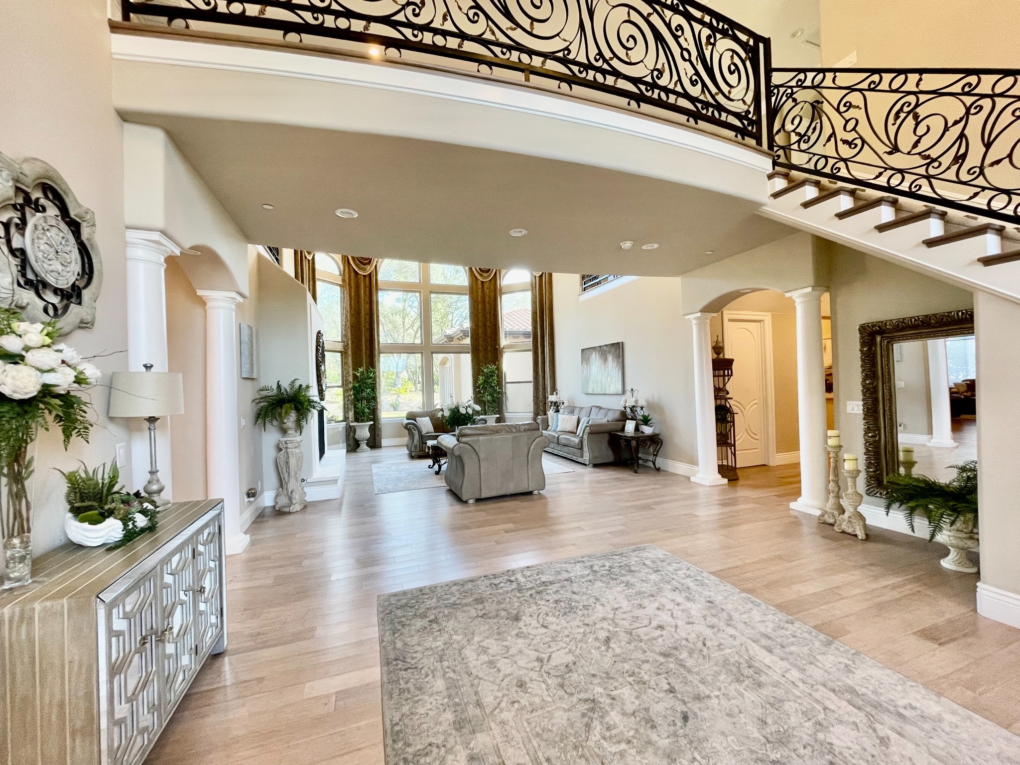 Original Loomis residence foyer with curved balcony railings, staircase and main floor